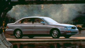 1995 Toyota Avalon in Gold near a lake