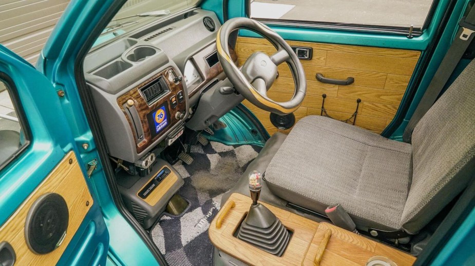 Wood trim interior of a 1996 Daihatsu Midget II compact pickup truck.