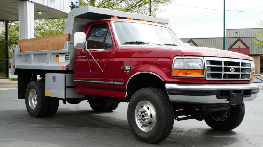 Red 1997 Ford F-350 dump bed truck with 1,500 miles
