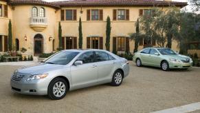 A set of used 2007 and 2008 Toyota Camry models park next to a hacienda.