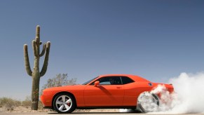 A 2010 Dodge Challenger does a burnout in the desert.
