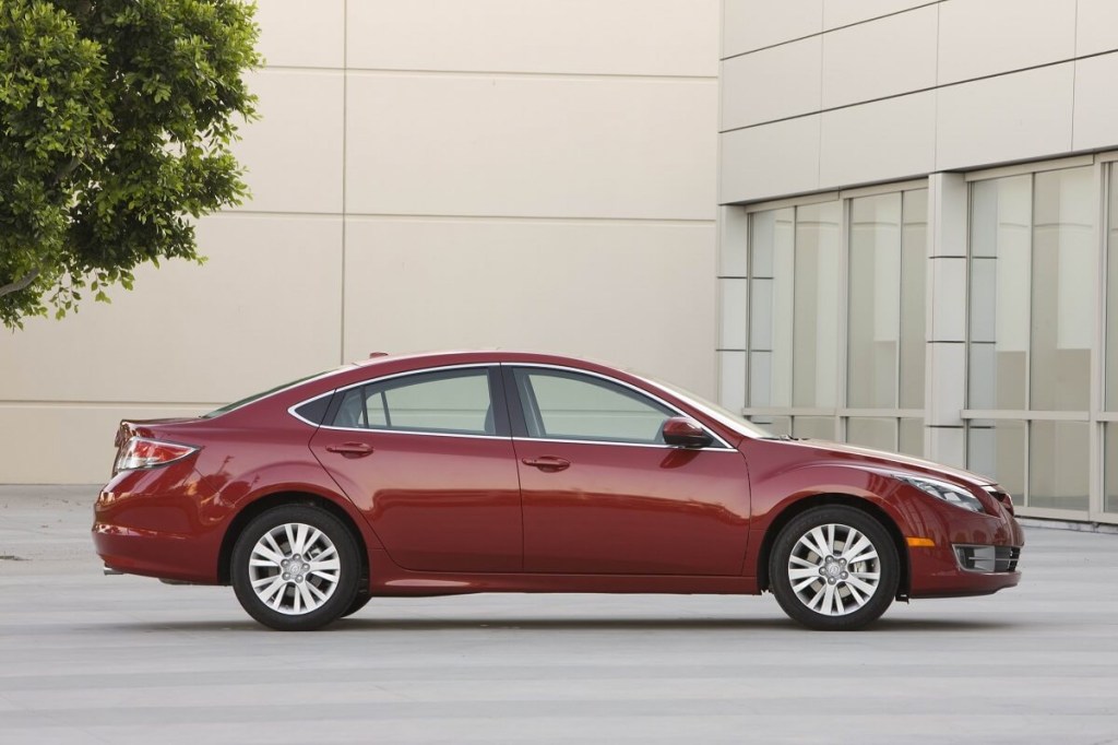 A 2010 Mazda6 shows off its pre-2012 styling while parked next to a large building.