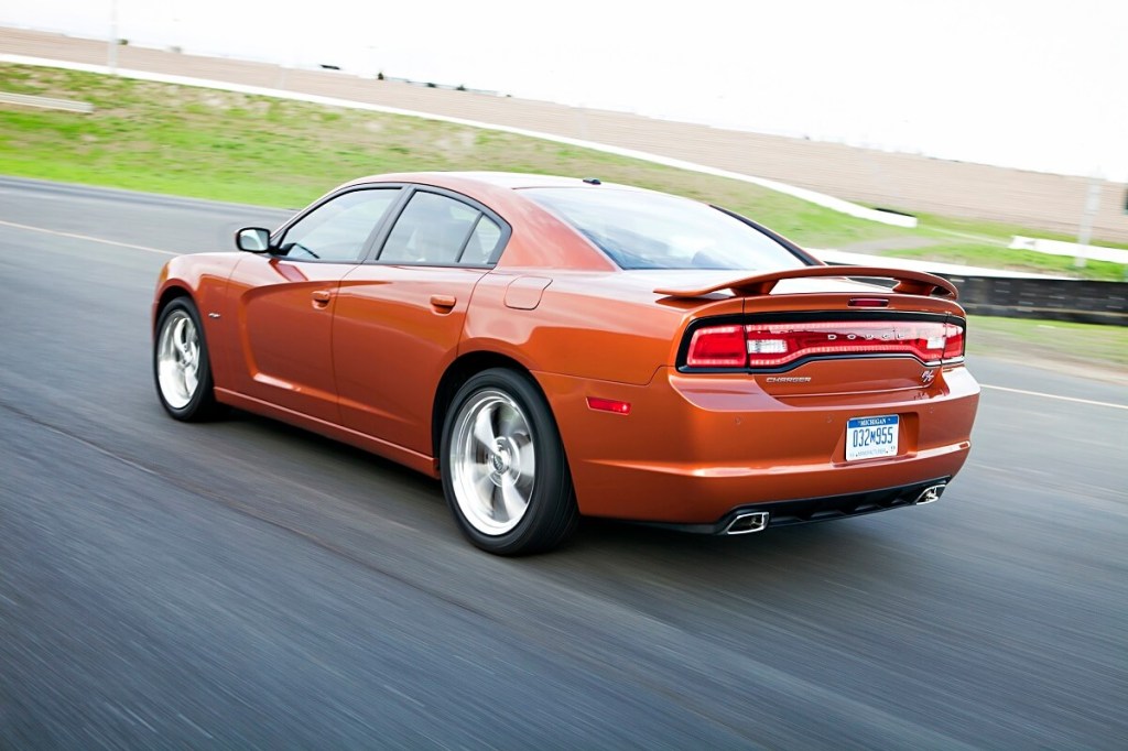 A 2011 Charger R/T sedan drives around a test track. 