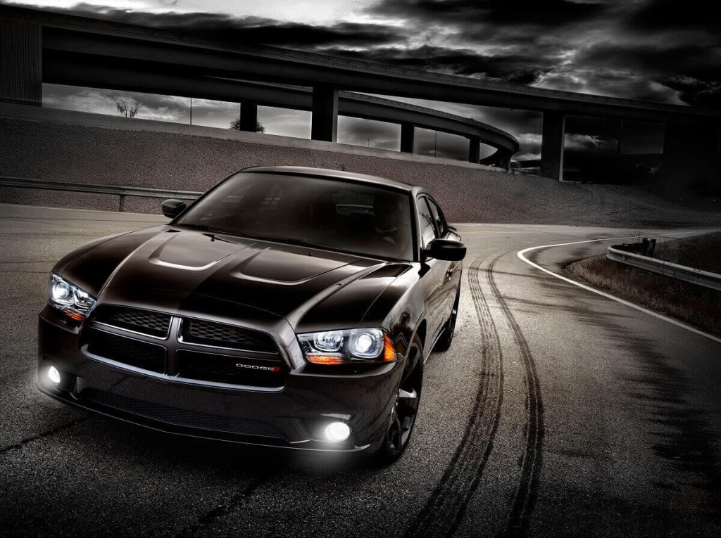 A used 2012 Dodge Charger Blacktop flashes its lights.