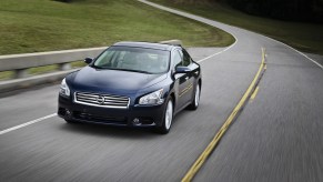 A used 2013 model year Nissan Maxima corners on back roads.