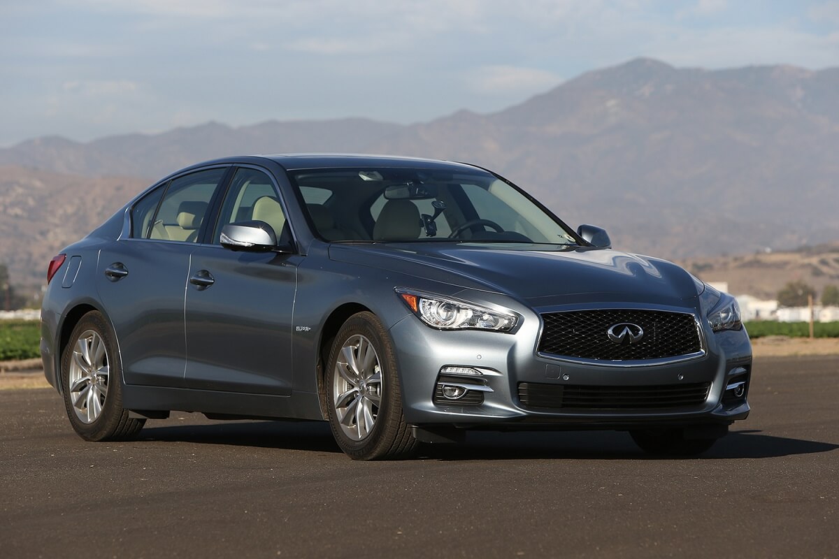 A used 2014 Infiniti Q50 shows off its luxury car styling on a runway.