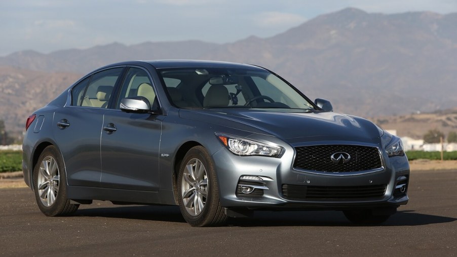 A used 2014 Infiniti Q50 shows off its luxury car styling on a runway.