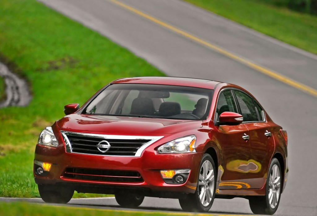 A red 2014 Nissan Altima takes a corner. 