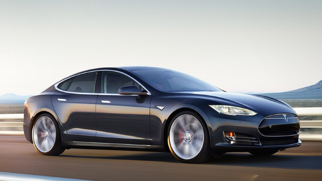 Black 2014 Tesla Model S on a road - This EV requires a battery replacement more often than most other electric vehicles
