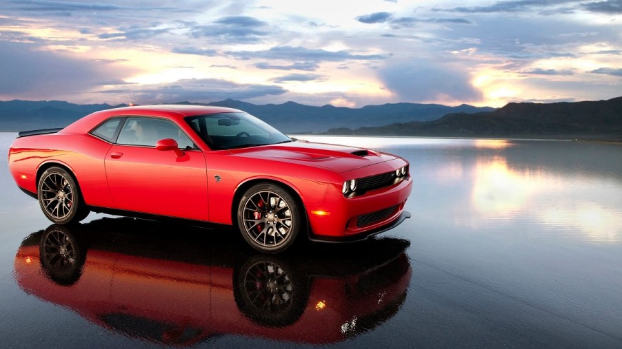 A bright-red 2015 Dodge Challenger SRT Hellcat reflects on a lake bed.