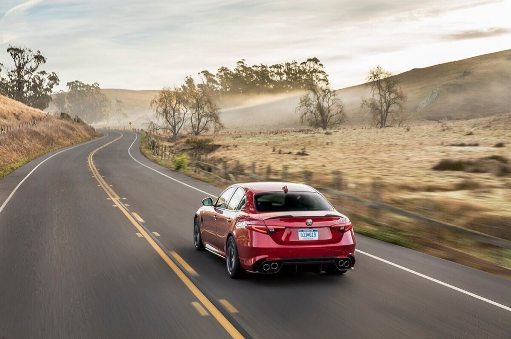 A used Alfa Romeo Giulia Quadrifoglio cruises desert streets.
