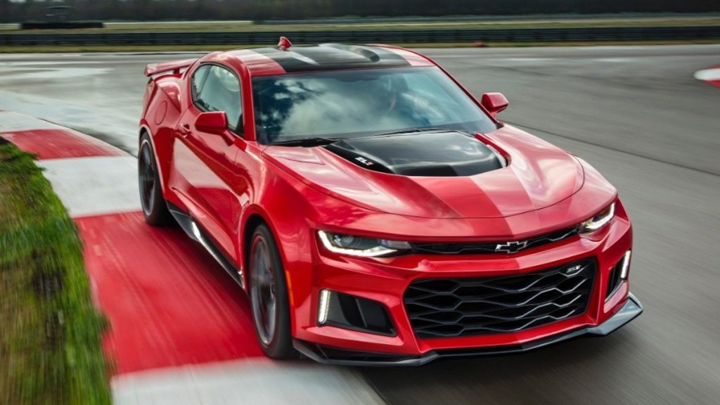 A Red 2017 Chevy Camaro ZL1 Racing Around a Track