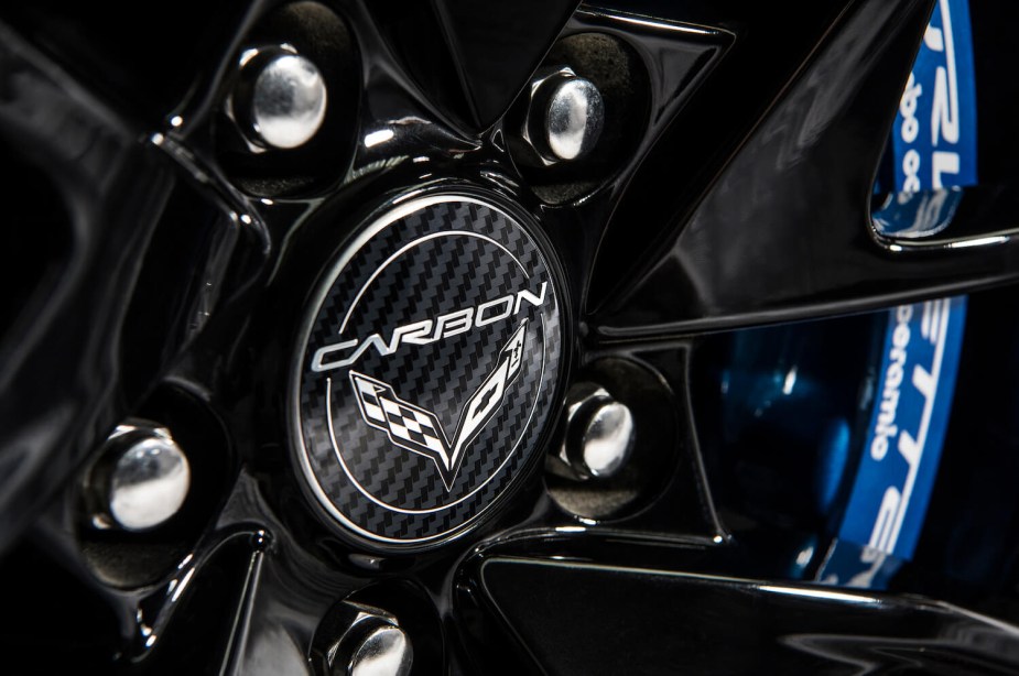 Closeup of the Chevy Corvette logo on the carbon fiber rim of a modern sports car.