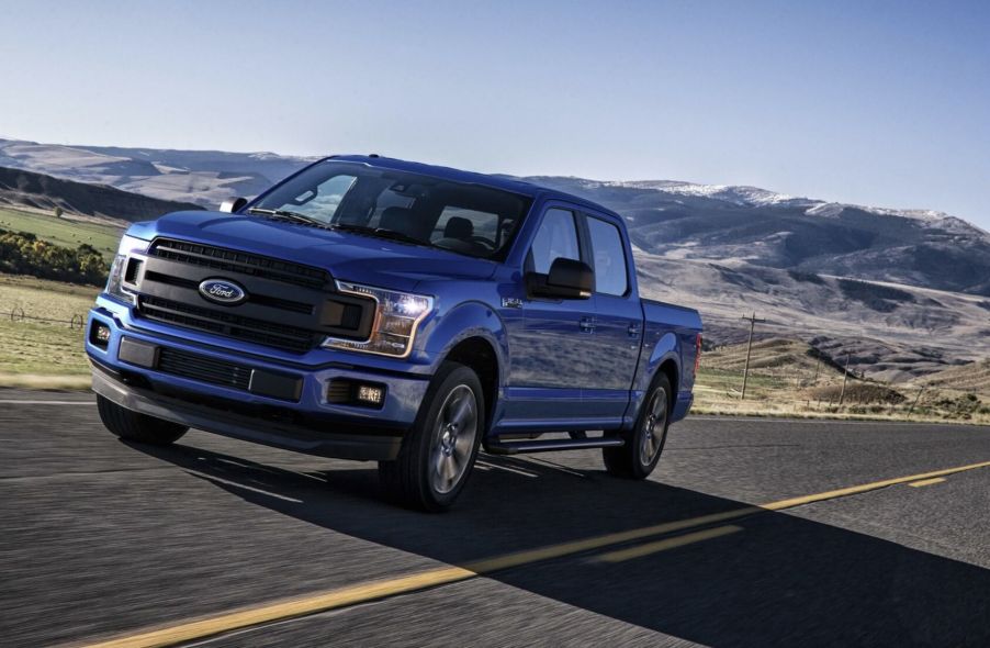 The 2018 Ford F-150 driving on a road in the wilderness