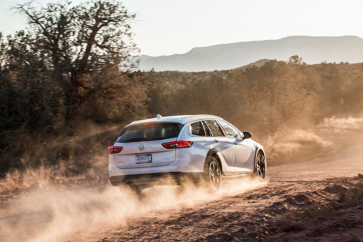 A rearview of the 2020 Buick Regal TourX driving through a desert