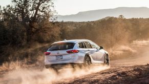 A rearview of the 2020 Buick Regal TourX driving through a desert