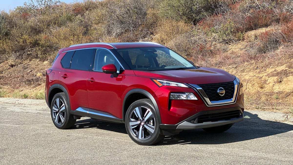 Red 2021 Nissan Rogue With a Grassy Hill Background - Most Common Nissan Rogue Problems