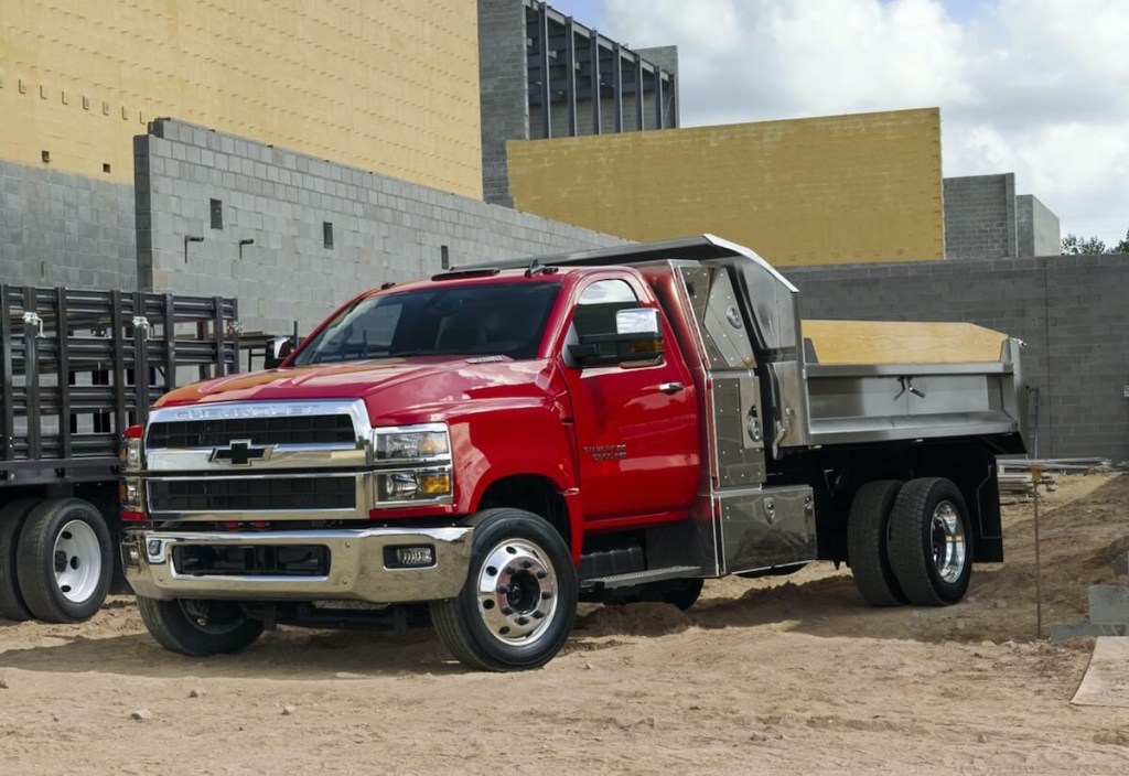 Red 2022 Chevrolet Silverado HD 4500 with dump body at work site