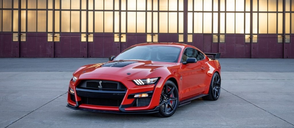 The 2022 Ford Mustang Shelby GT500, the fastest production Mustang ever, poses by a hangar. 