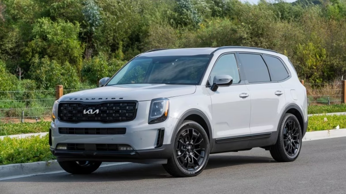 White 2022 Kia Telluride Parked Next to a Curb with trees in the background - This midsize Kia SUV can be great for families