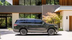 A 2022 Lincoln Navigator, a third-row luxury SUV, parked in front of a modern building.
