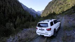 A white 2022 Toyota Sequoia TRD Pro, the last with a V8 engine, scales a mountain trail.