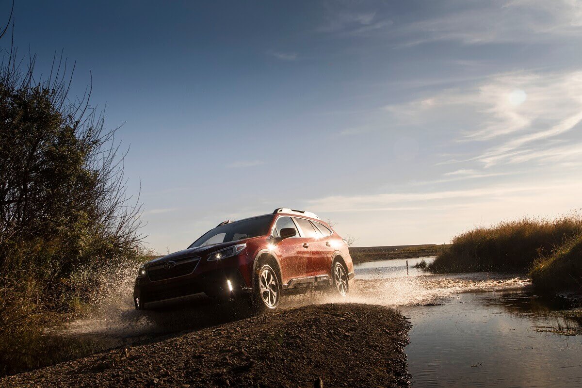 A Subaru Outback uses AWD to climb out of the water.