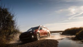A Subaru Outback uses AWD to climb out of the water.