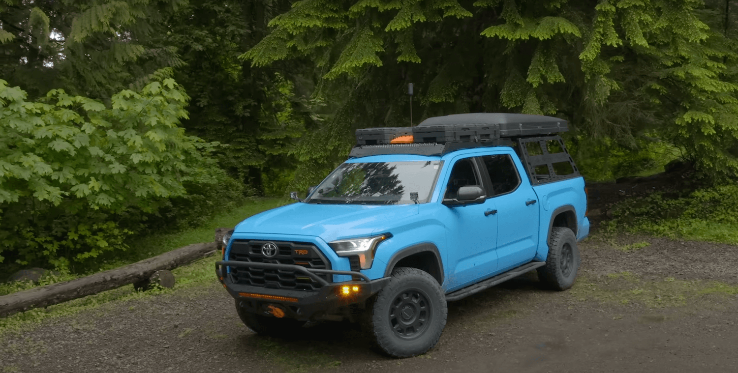 A blue 2022 Toyota Tundra 3rd gen truck modified for overland off-roading, with 40k in mileage.