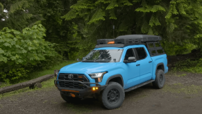 A blue 2022 Toyota Tundra 3rd gen truck modified for overland off-roading, with 40k in mileage.