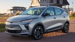 A gray 2023 Chevrolet Bolt EUV subcompact SUV is parked on the beach.