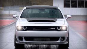 A 2023 Dodge Challenger SRT Demon 170 flashes its LED lights on the drag strip.