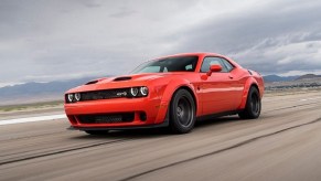 A 2023 Dodge Challenger SRT Hellcat Redeye blasts down a runway.