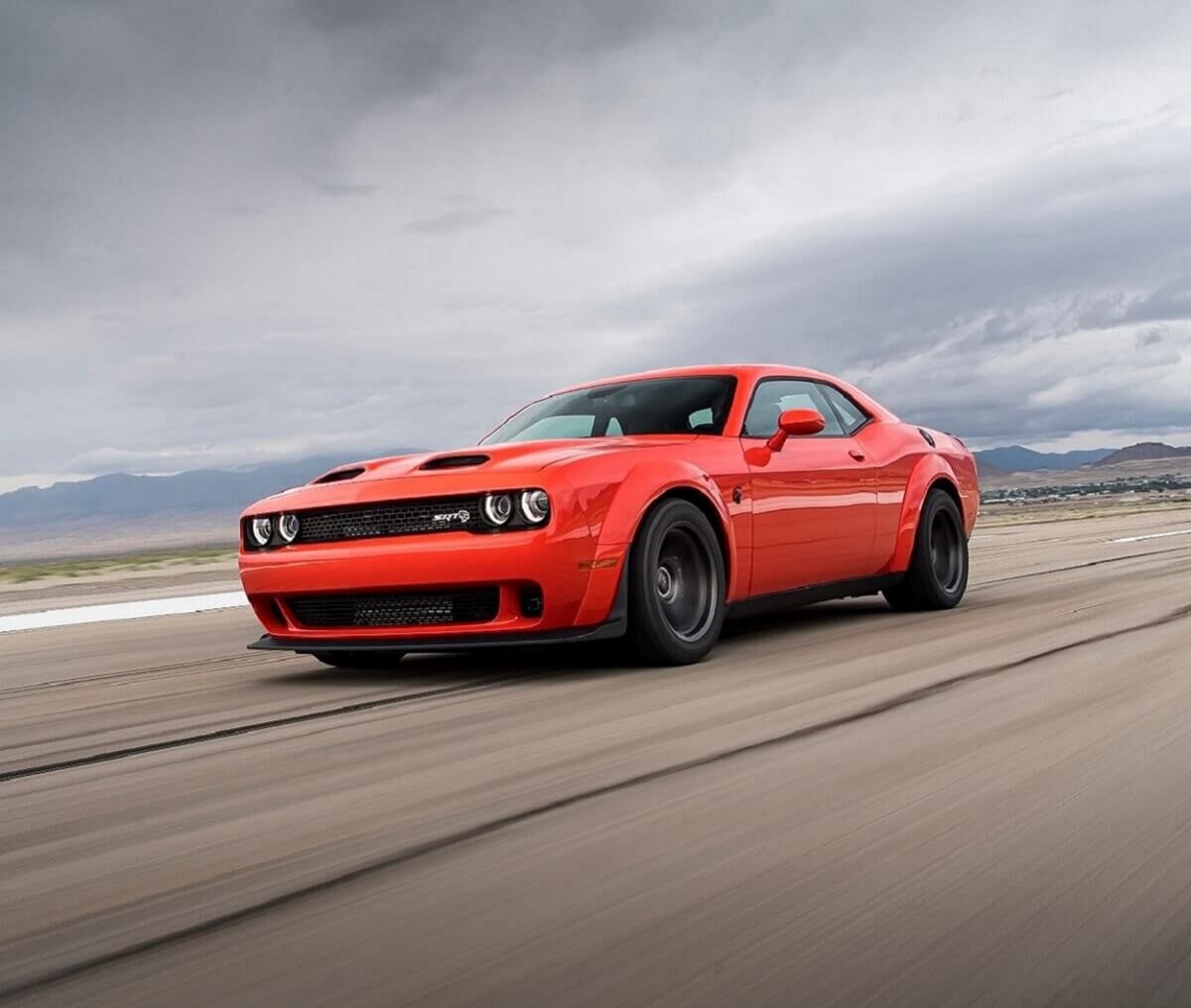 A 2023 Dodge Challenger SRT Hellcat Redeye blasts down a runway.