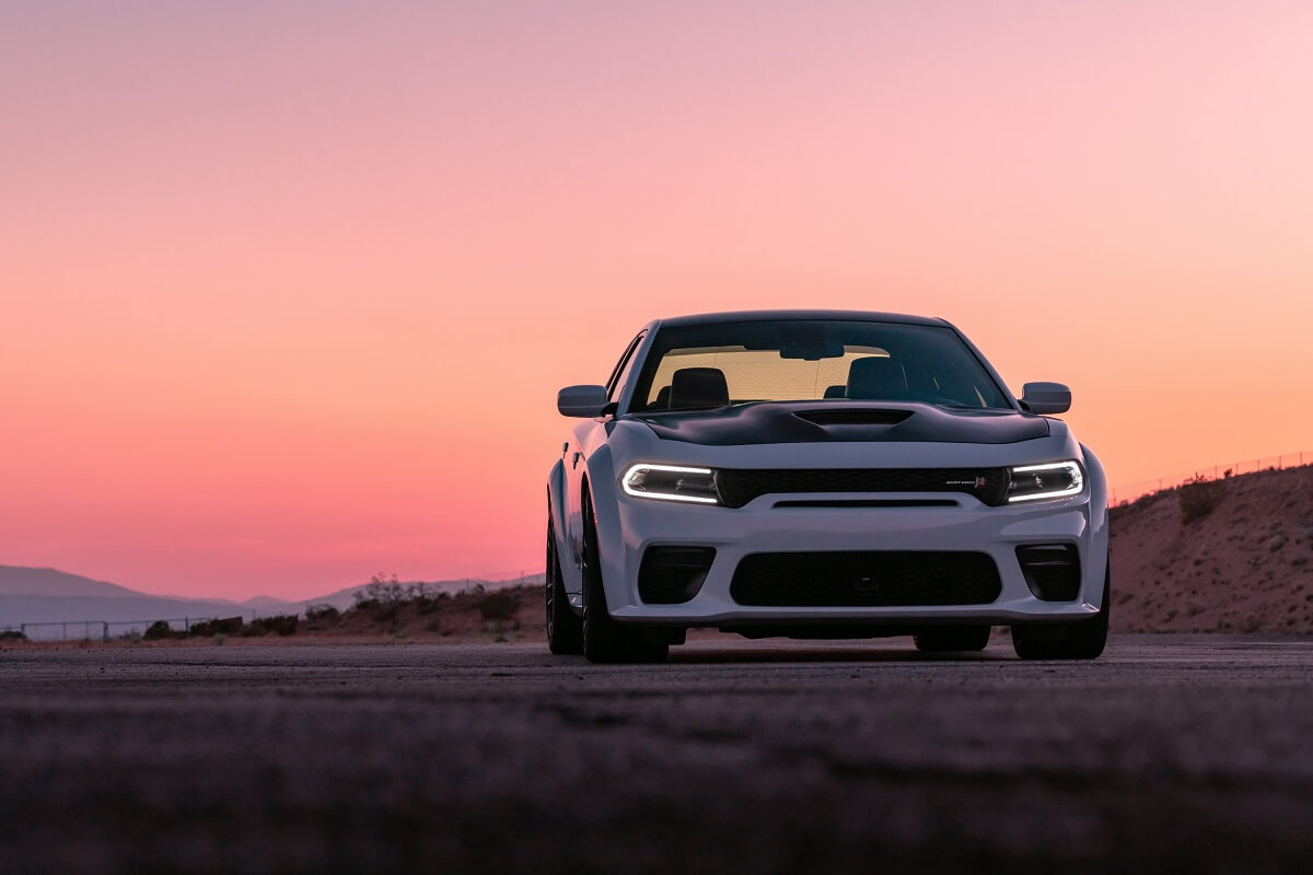 A white 2023 Dodge Charger RT Scat Pack Widebody shows off its muscular stance.
