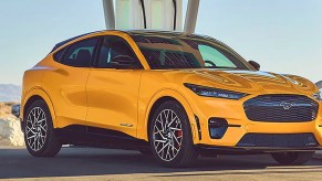 A yellow 2023 Ford Mustang Mach-E small electric SUV is parked.