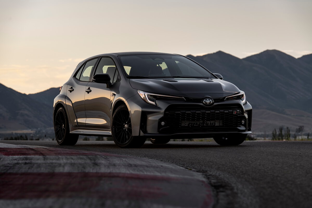 A dark gray Toyota GR Corolla shines on a test track, borrowing tech from the GR Yaris