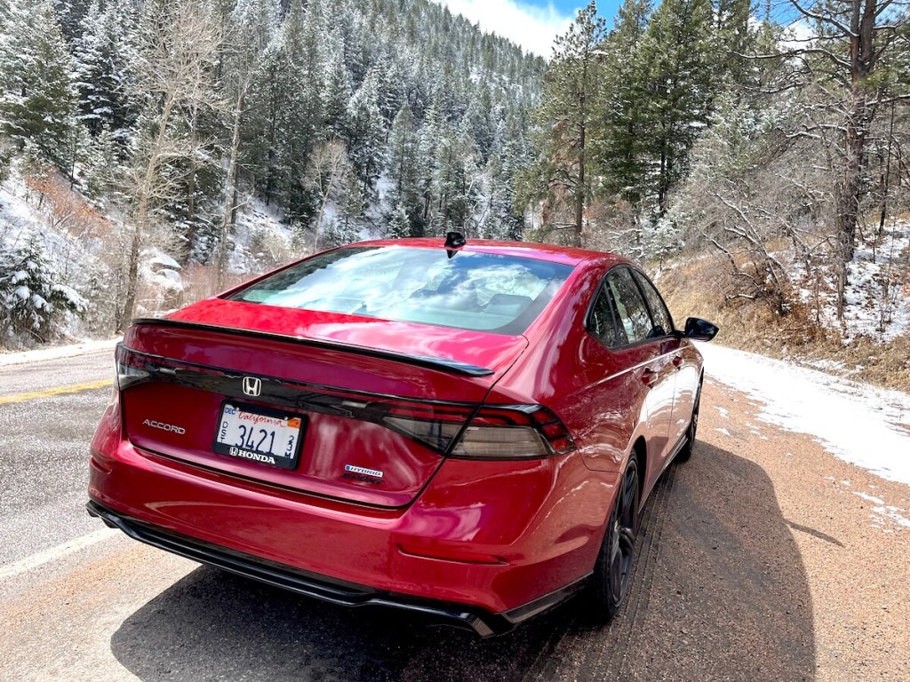 A rear view of the new 2023 Honda Accord Hybrid in a canyon.