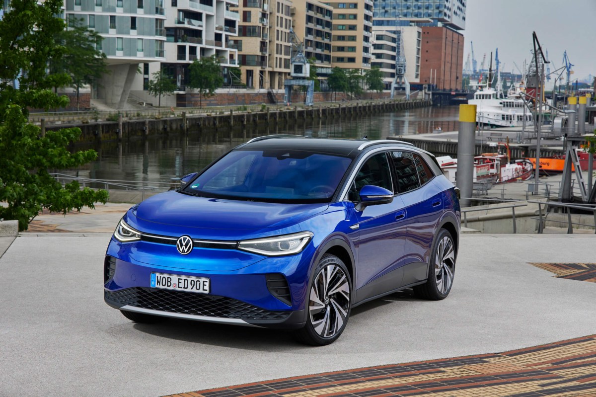 The 2023 ID.4 is Volkswagen's flagship EV that's full of features. Here, the blue model is parked in front of a canal in the city.