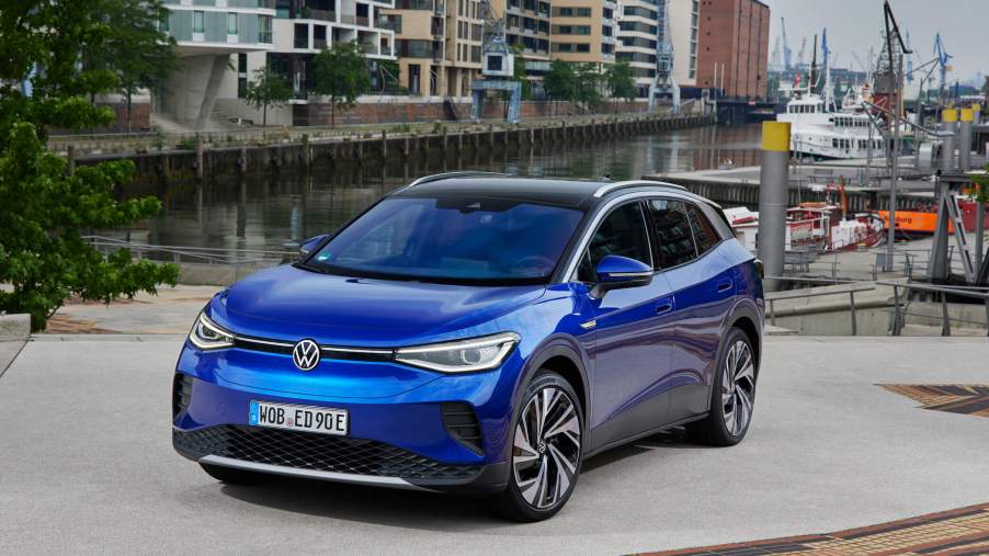 The 2023 ID.4 is Volkswagen's flagship EV that's full of features. Here, the blue model is parked in front of a canal in the city.