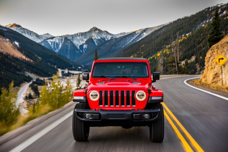 red 2023 Jeep Wrangler Rubicon driving 
