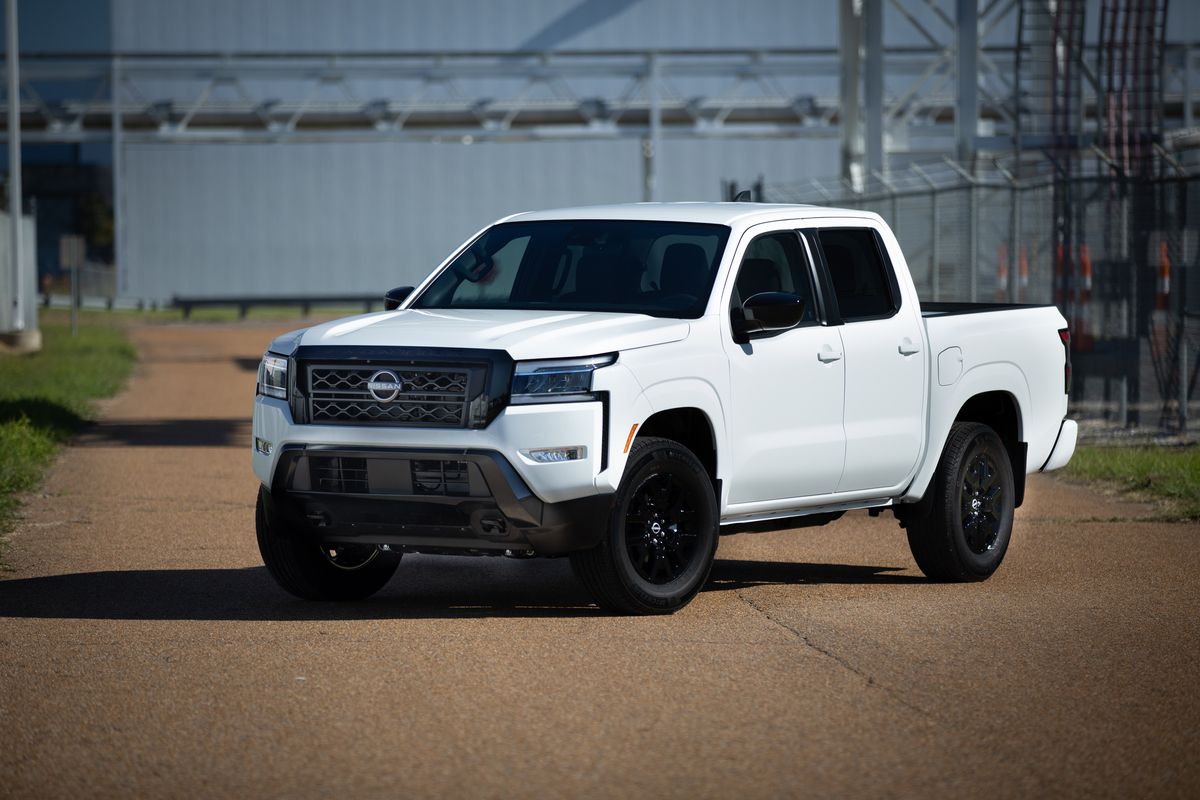 A white 2023 Nissan Frontier on display.