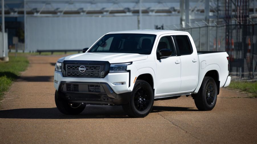 A white 2023 Nissan Frontier on display.
