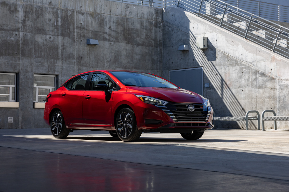 The 2023 Nissan Versa got a mild facelift. Shown here in red parked. 