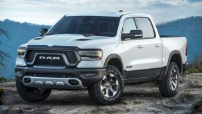 A white 2023 Ram 1500 parked on an rock.