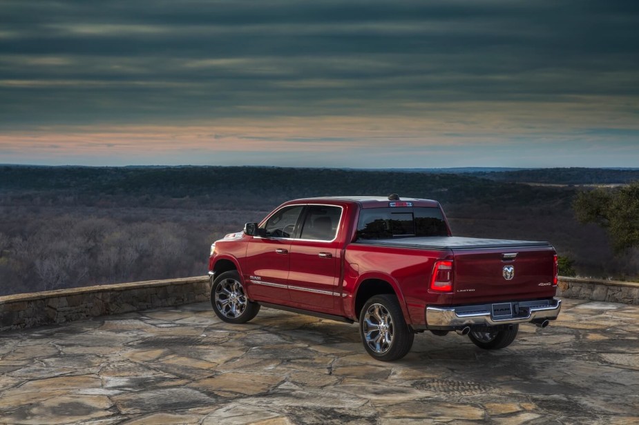Red Ram 1500 pickup truck parked facing a valley below, the horizon visible in the background