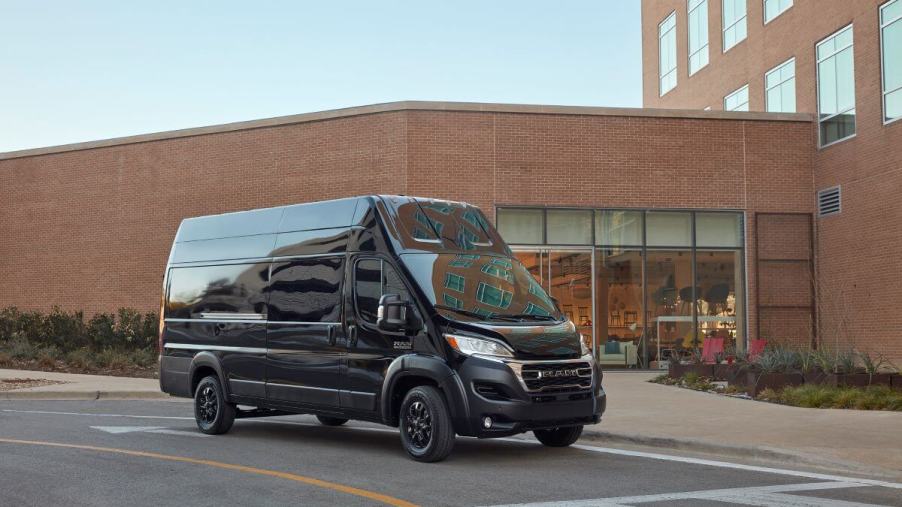 A black 2023 Ram ProMaster with a high roof commercial vehicle van model parked at a crosswalk