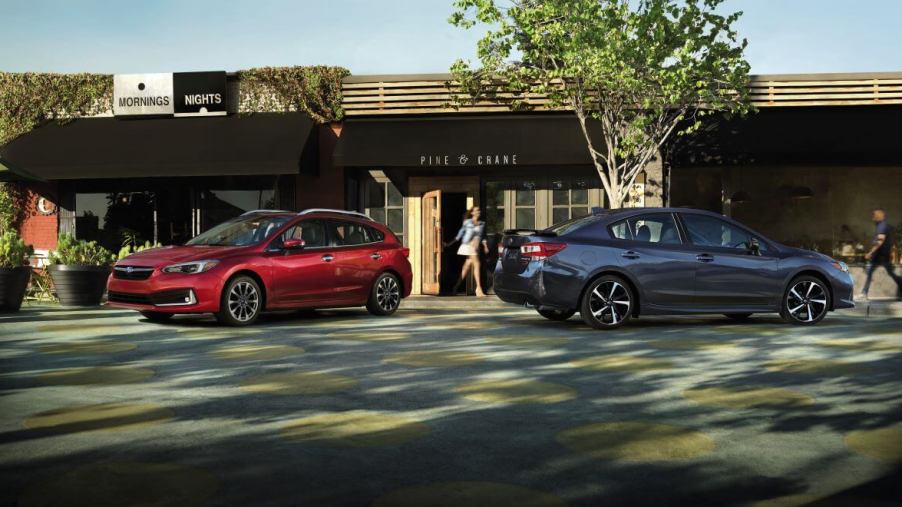 The 2023 Subaru Impreza lineup, featuring a red Impreza hatchback and a gray Impreza sedan
