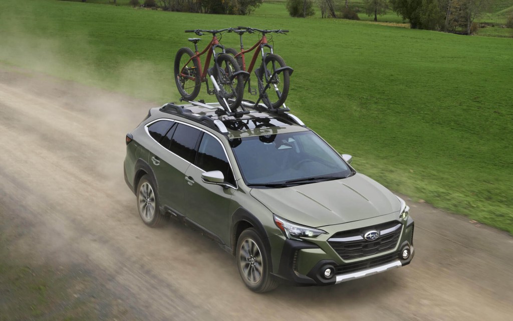 The 2023 Subaru Outback driving on a dirt road