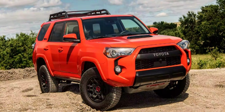 An orange 2023 Toyota 4Runner is parked off-road. 
